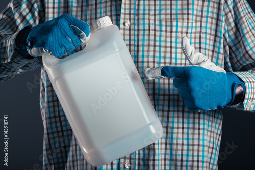 Farmer with plastic tenk canister with pesticides photo