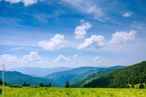 Mountain valley landscape with blue sky. Summer time.