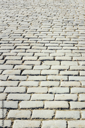 Tiled with paving stone bricks path s fragment as an abstract background