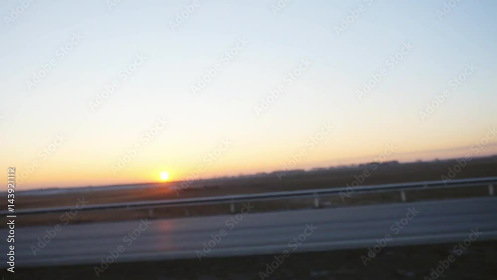 Car driving a countryside road in sunset time changes focus to blurred in slow motion. 1920x1080 Car driving a countryside road in sunset time changes focus to blurred in slow motion. 1920x1080