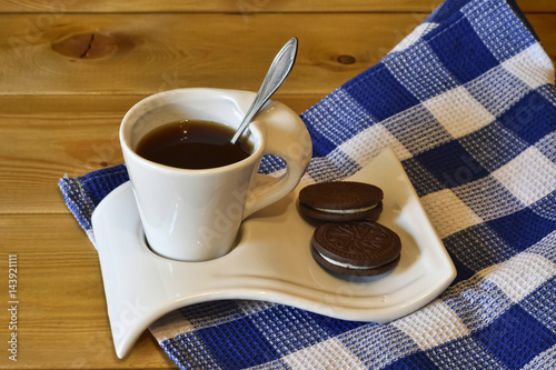 A cup of coffee and biscuits photo