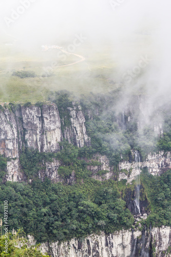 Fog covering waterfall canyon