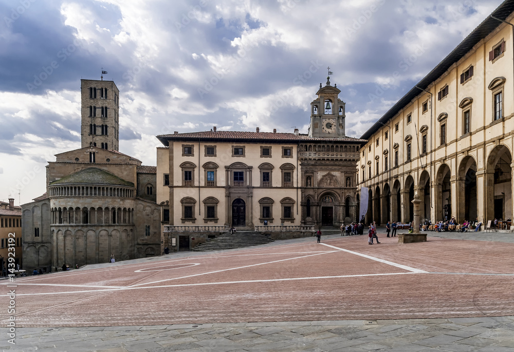 Beautiful view of the Piazza Grande square in the historic center of Arezzo, Tuscany, Italy, under a dramatic sky