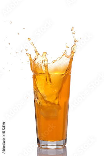 Splash in glass of orange juice with ice