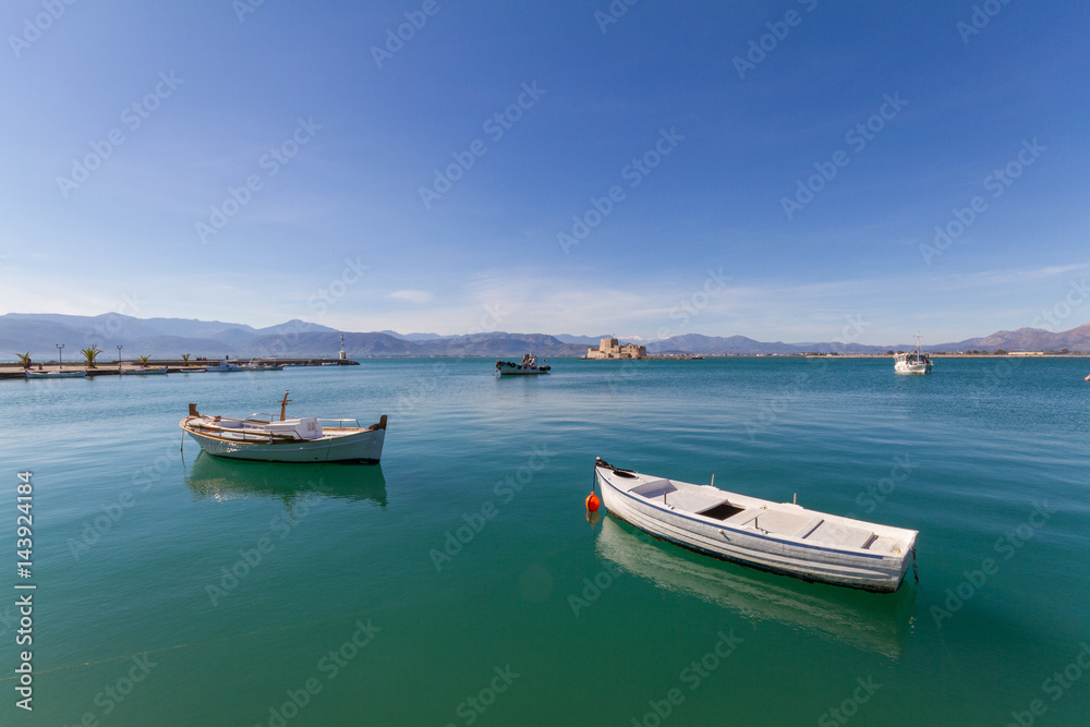 Fishing Boats, Lightouse and Bourtzi Fortress in Nafplion, Greece- wide-angle photo