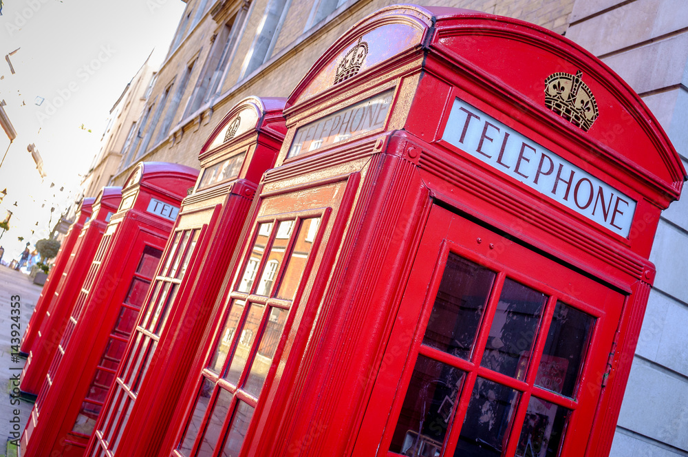 Iconic British red telephone boxes in a London street Iconic British red telephone boxes in a London street