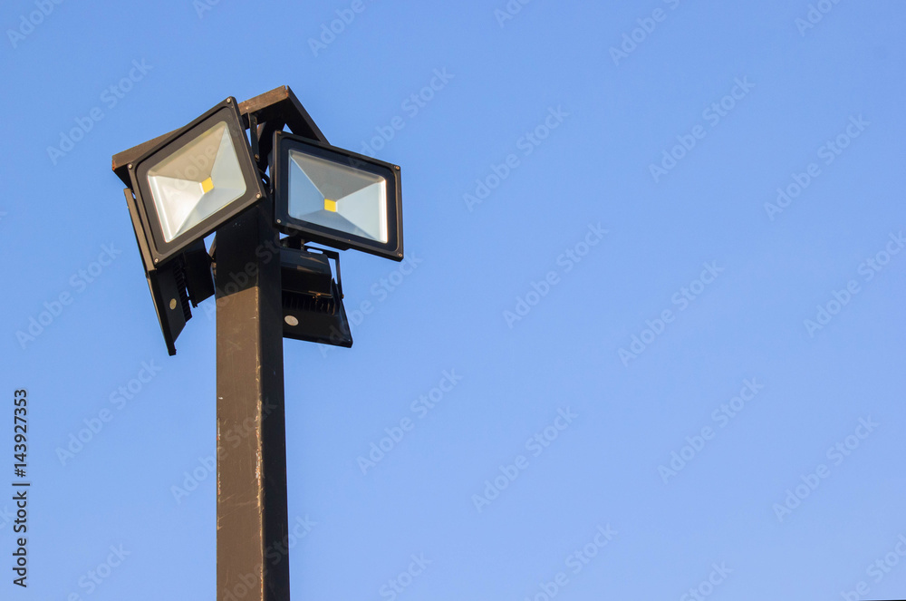 Spotlight, Lamp post on blue sky background with copy space Spotlight, Lamp post on blue sky background with copy space