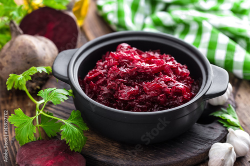 Beetroot salad on wooden background closeup
