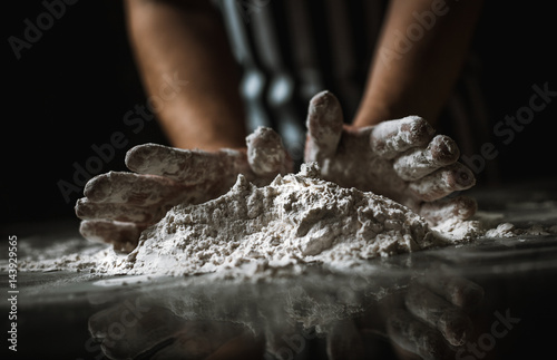 Male chef prepares a meal of flour