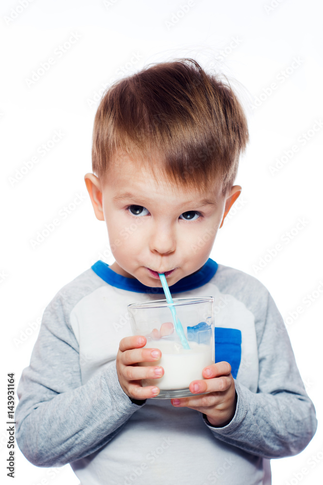 Healthy bones, happy kids. Adorable little boy drinking milk through a straw Healthy bones, happy kids. Adorable little boy drinking milk through a straw