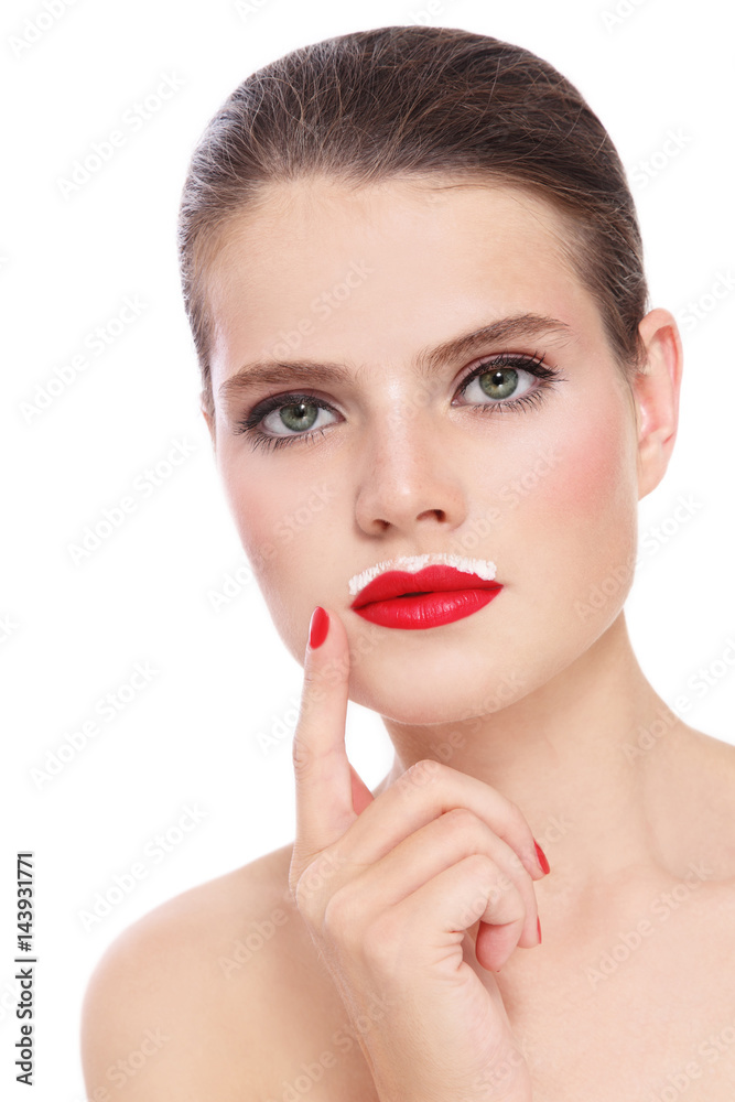 Young beautiful healthy woman with red lipstick and milk moustache over white background Young beautiful healthy woman with red lipstick and milk moustache over white background