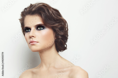 Young beautiful woman with stylish make-up and curly hair