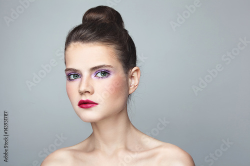 Young beautiful woman with stylish make-up and hair bun