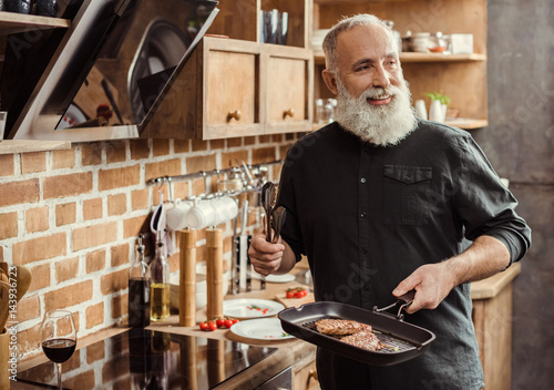 Man cooking steaks