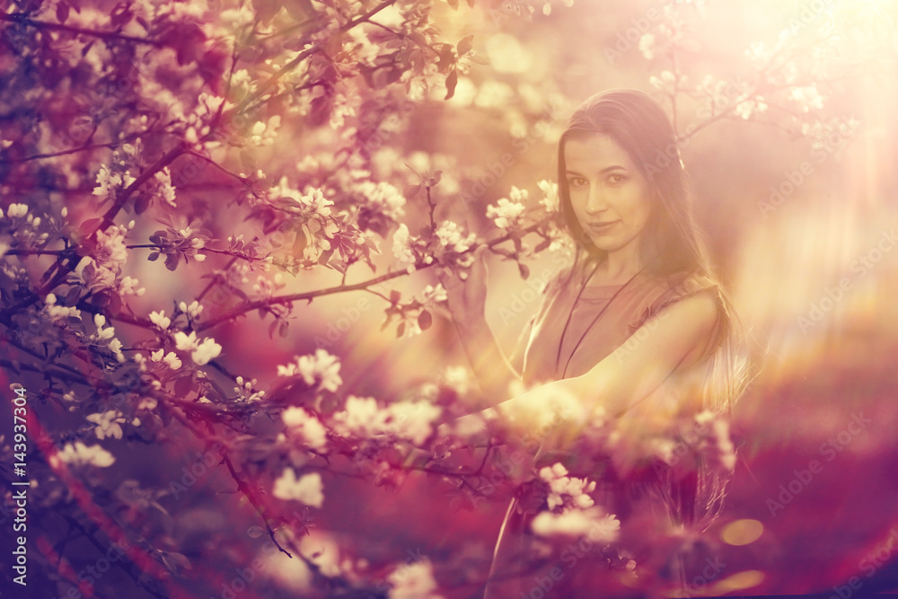 Spring portrait in apple blossoms young adult beautiful girl