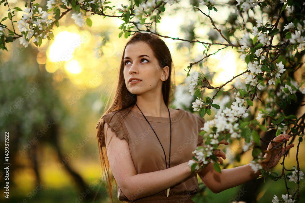 Cherry blossoming garden in spring beautiful adult young girl relaxing