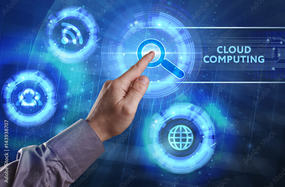 Business, Technology, Internet and network concept. Young businessman working on a virtual screen of the future and sees the inscription: Cloud computing Business, Technology, Internet and network concept. Young businessman working on a virtual screen of the future and sees the inscription: Cloud computing