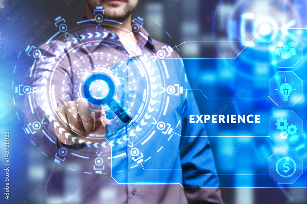 Business, Technology, Internet and network concept. Young businessman working on a virtual screen of the future and sees the inscription: Experience Business, Technology, Internet and network concept. Young businessman working on a virtual screen of the future and sees the inscription: Experience
