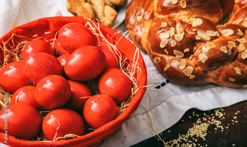 Easter eggs and greek tsoureki on a table photo