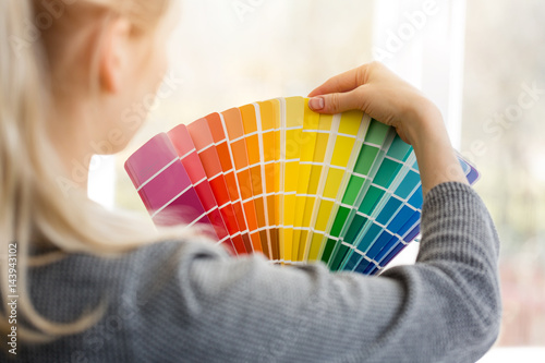Fototapeta woman designer choosing interior design color from swatch palette