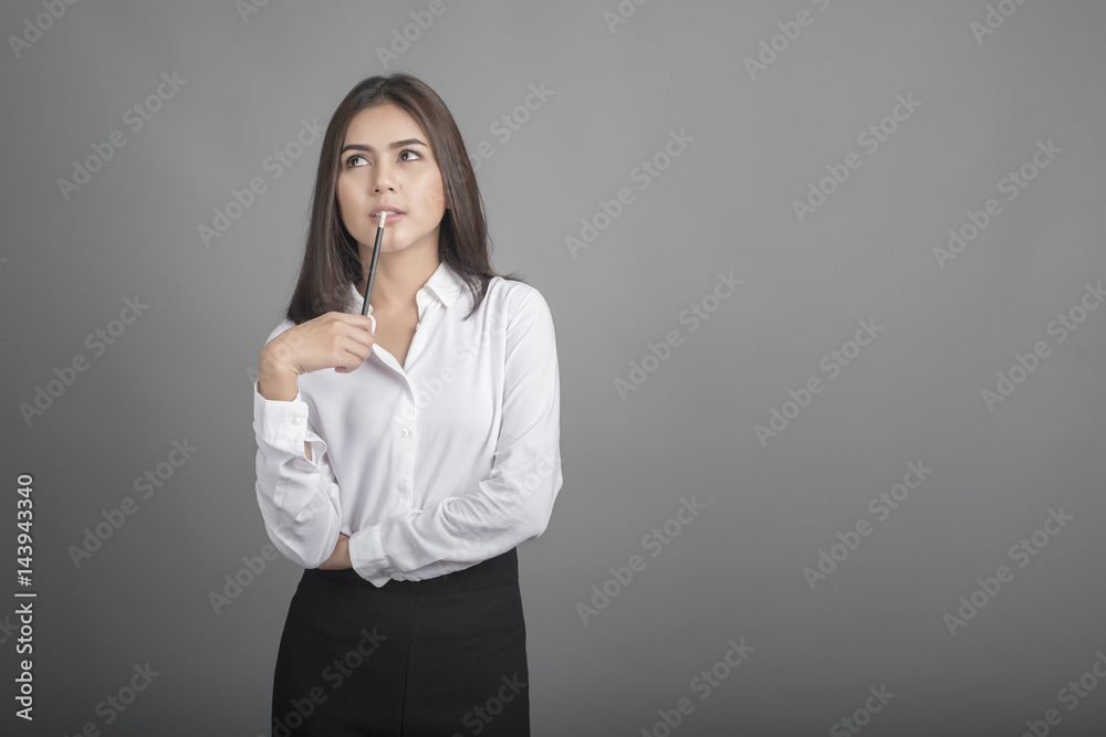 Beautiful Business Woman thinking on grey background Beautiful Business Woman thinking on grey background