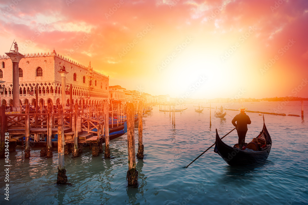 Venetian gondoliers await some tourists to carry around on a gondola in Venice - obrazy, fototapety, plakaty 