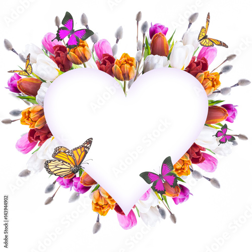 Fototapeta Naklejka Na Ścianę i Meble -  Spring tulips in a heart shape. Floral background of flowers and butterflies.