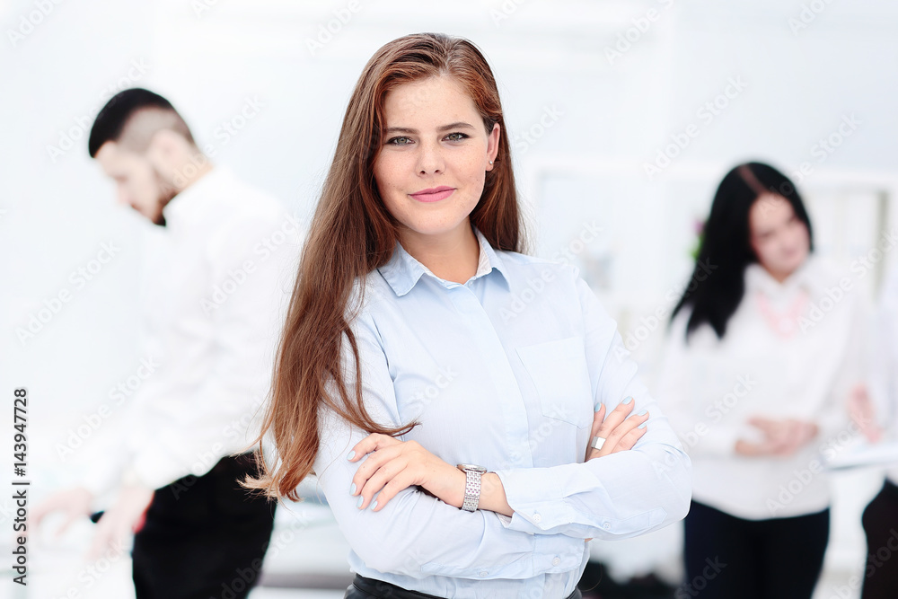 Happy businesswoman with colleagues in the background Happy businesswoman with colleagues in the background