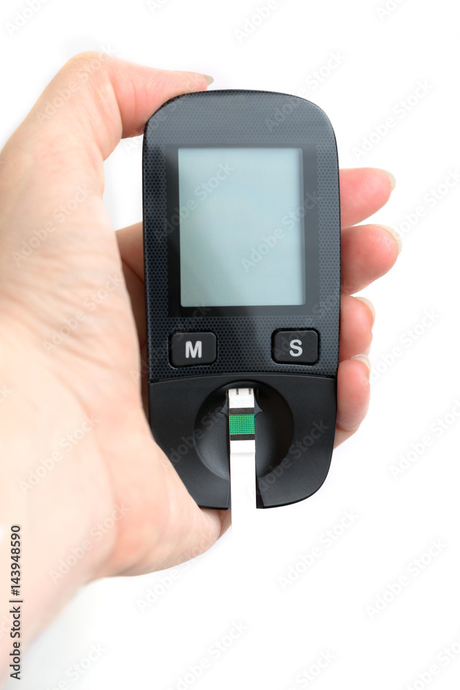 A young woman holds a glucometer in her hands and wants to do a blood test for sugar A young woman holds a glucometer in her hands and wants to do a blood test for sugar