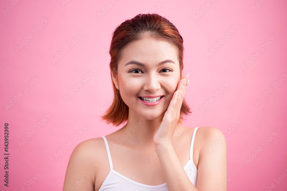 Portrait of a beautiful smiling young woman with natural make-up. Skincare, healthcare. Healthy teeth. Studio shot. Isolated on Pink Background. Portrait of a beautiful smiling young woman with natural make-up. Skincare, healthcare. Healthy teeth. Studio shot. Isolated on Pink Background.