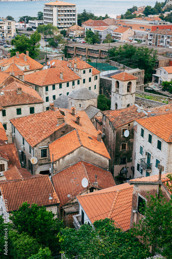The Old Town of Kotor. The orange-tiled rooftops of the city. Shooting from the observation platform on the wall of the city. Montenegro