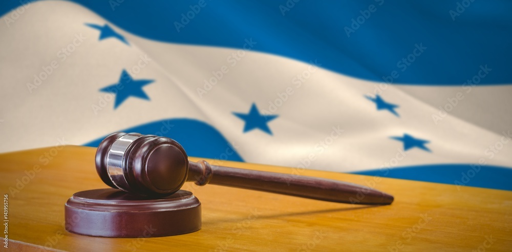 Composite image of close up of gavel on table