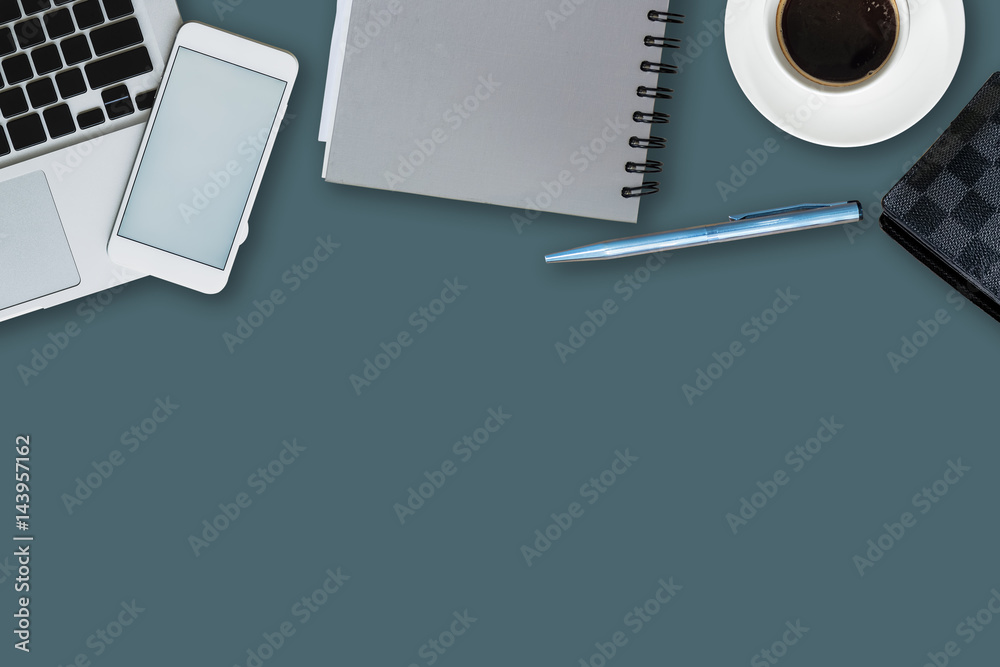 office equipment,laptop computer, smartphone with white screen over a notebook and cup of coffee. Top view with copy space, flat lay.