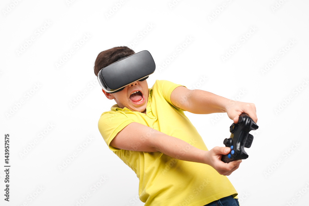 Excited boy with gamepad and VR goggles. Excited boy with gamepad and VR goggles.