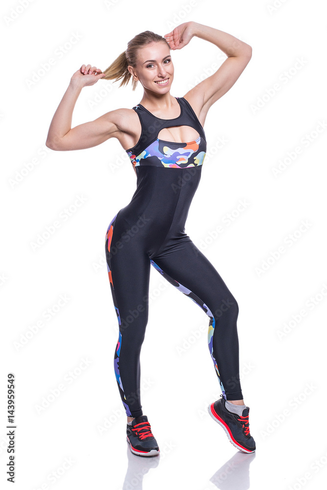 Cute athletic girl posing in the studio isolated on white background. Young woman bodybuilder or fitness coach wearing sportswear tracksuit. Cute athletic girl posing in the studio isolated on white background. Young woman bodybuilder or fitness coach wearing sportswear tracksuit.