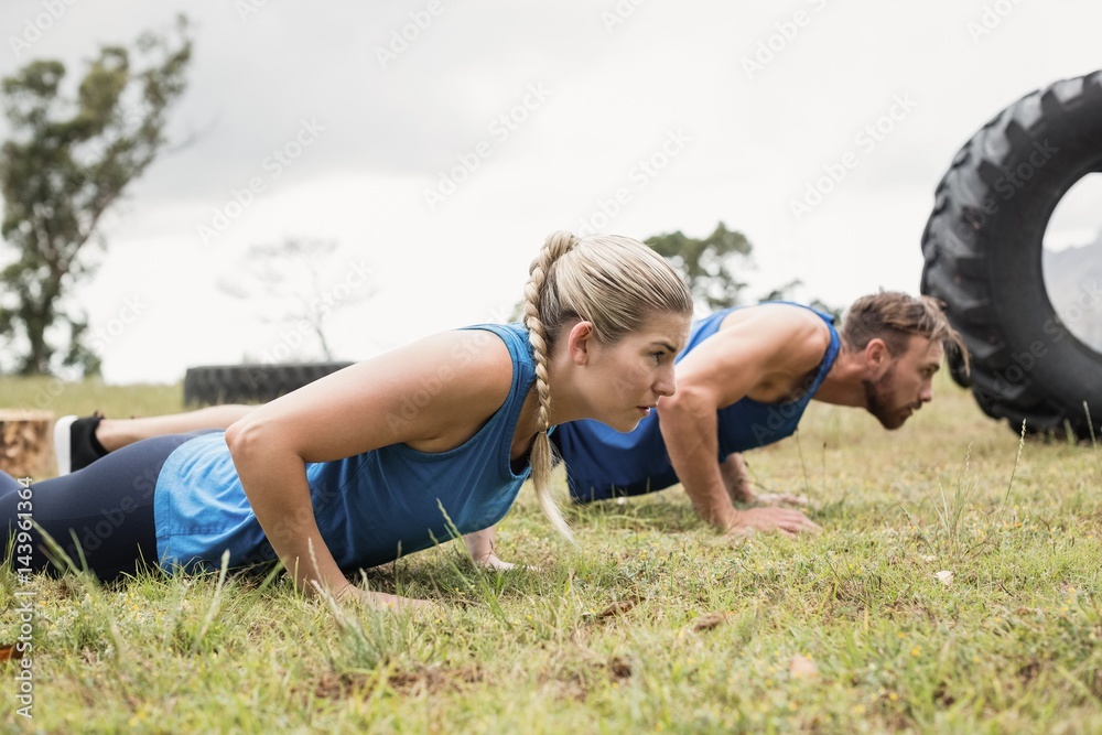 Fit people performing pushup exercise Fit people performing pushup exercise