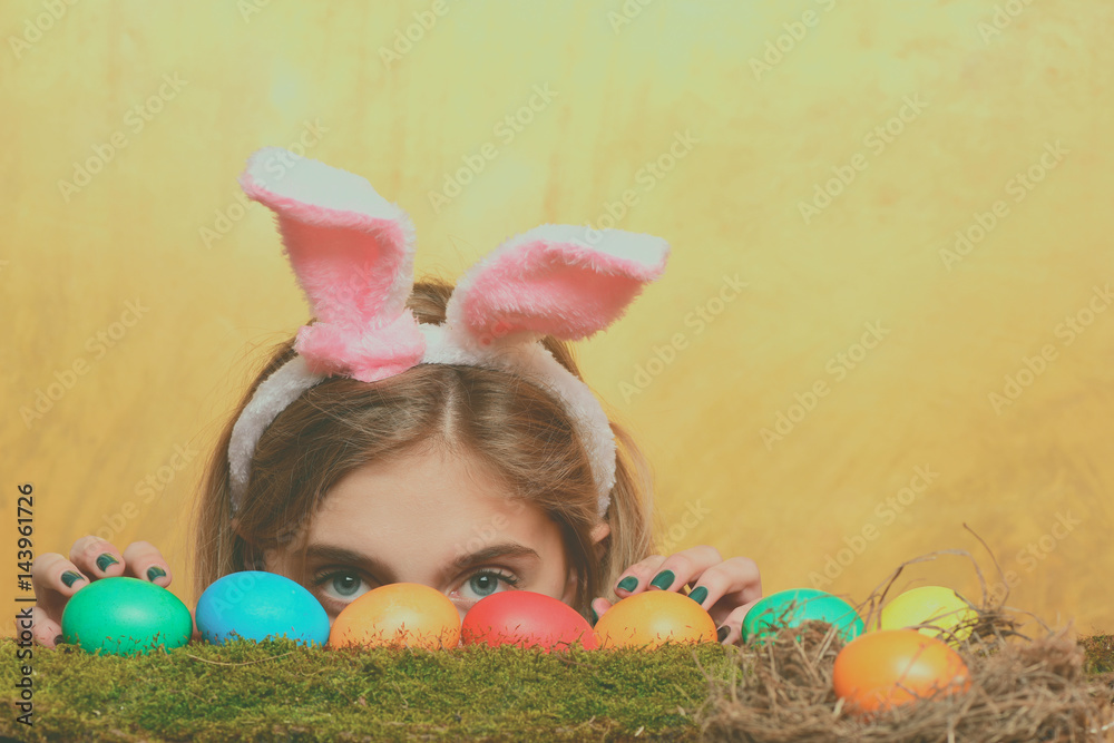 happy easter girl in bunny ears with colorful eggs, moss happy easter girl in bunny ears with colorful eggs, moss
