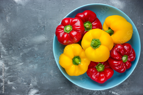 Red bell pepper and yellow bell pepper on plate photo