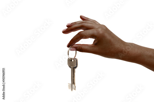 African female hand holds keys on white background.