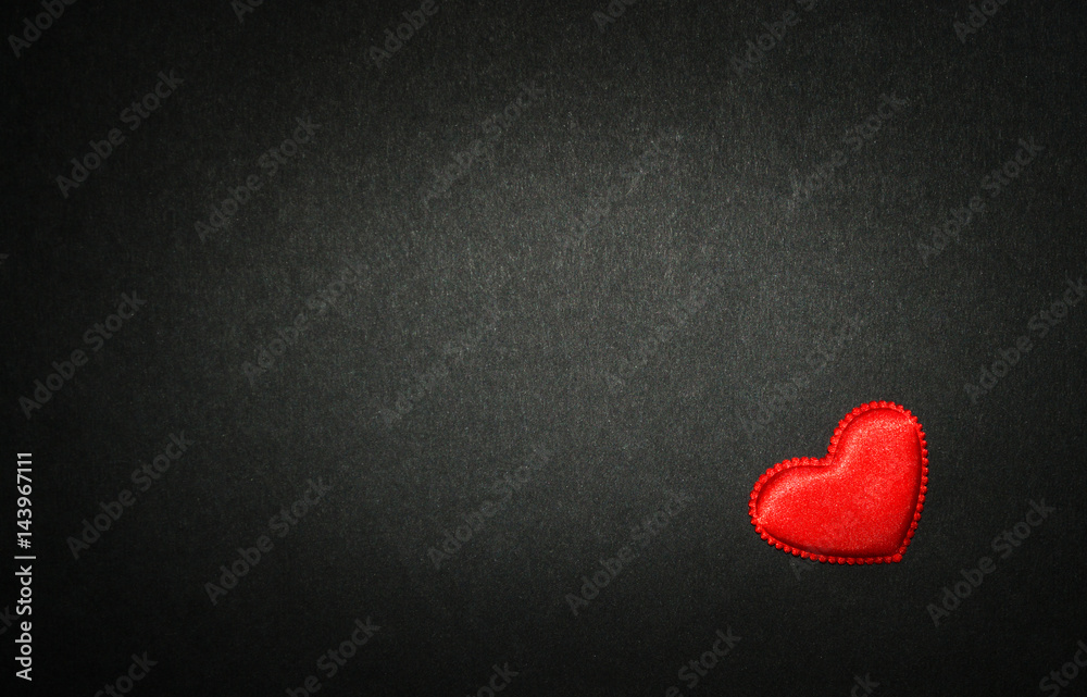 Obraz premium Red heart isolated on black paper. Love concept. Top view.