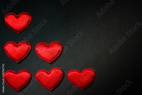 Red heart isolated on black paper. Love concept. Top view.