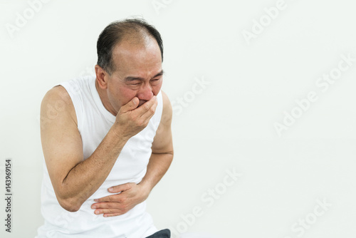 Asian senior man sneezing. Illness, allergy, diseases, cold, flu concept. Copy space.
