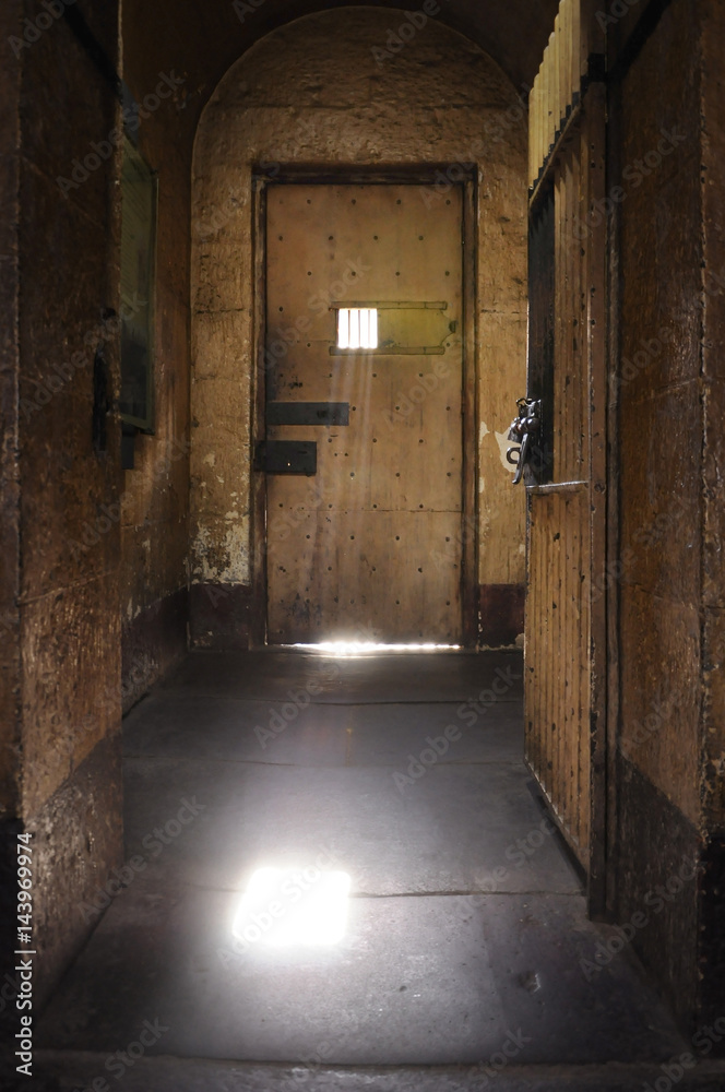 old style prison door and window with lens flare