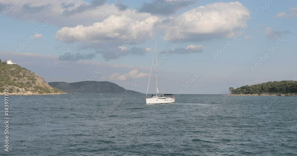 White boat with mast sailing in lagoon. Ship turn around and close up, beautiful clouds and islands on the background. White boat with mast sailing in lagoon. Ship turn around and close up, beautiful clouds and islands on the background.