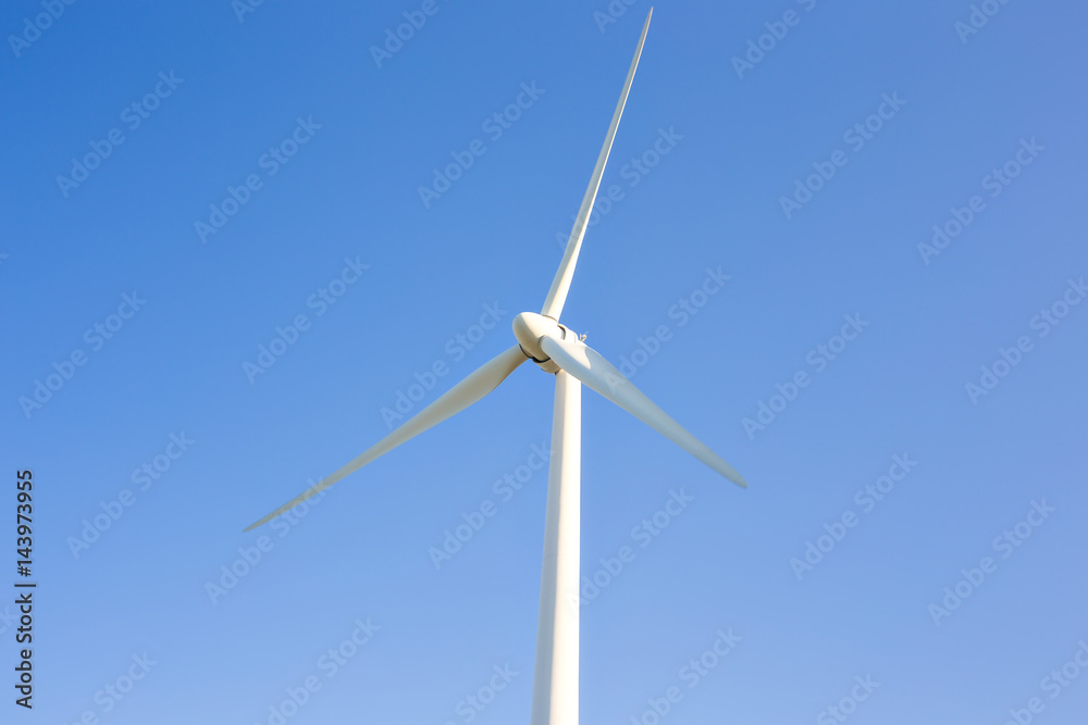 Wind turbine generating electricity with blue sky - energy conservation concept Wind turbine generating electricity with blue sky - energy conservation concept