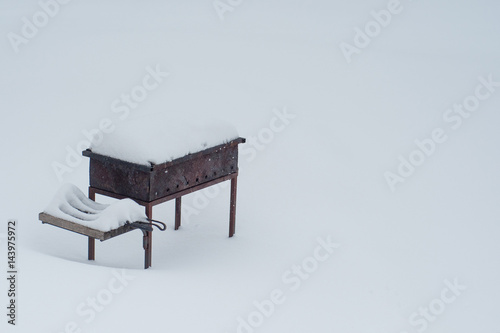 Sparrows on snow-covered brazier