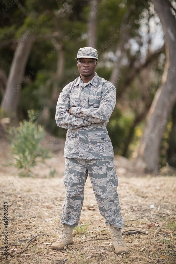 Military soldier standing with arms crossed