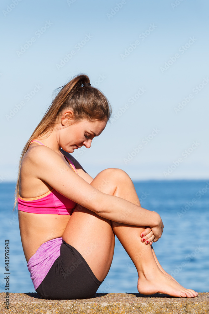 Woman doing sports exercises outdoors by seaside Woman doing sports exercises outdoors by seaside