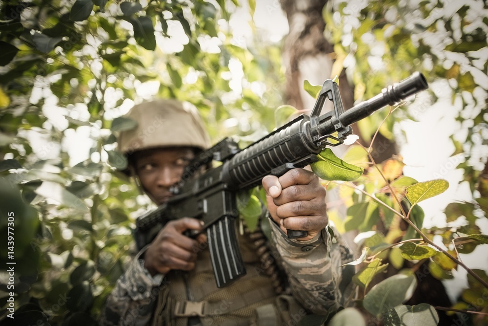 Military soldier guarding with a rifle