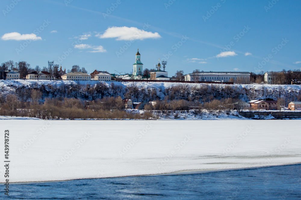 Naklejka premium The river is covered with melting ice on a sunny spring day